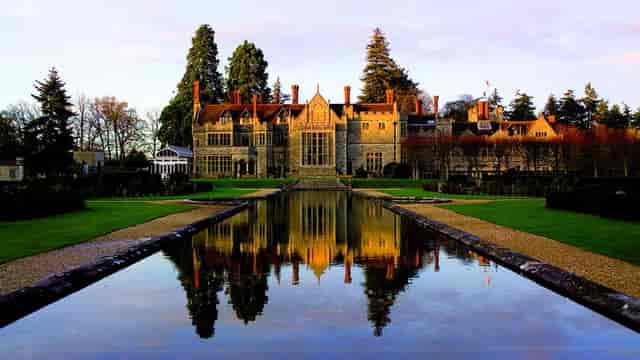Historic Rhinefield House Hotel with elegant architecture, ideal for upscale events and weddings.