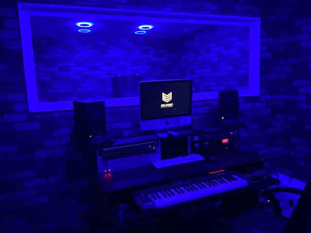 Modern recording studio with blue lighting, ideal for music events and workshops.