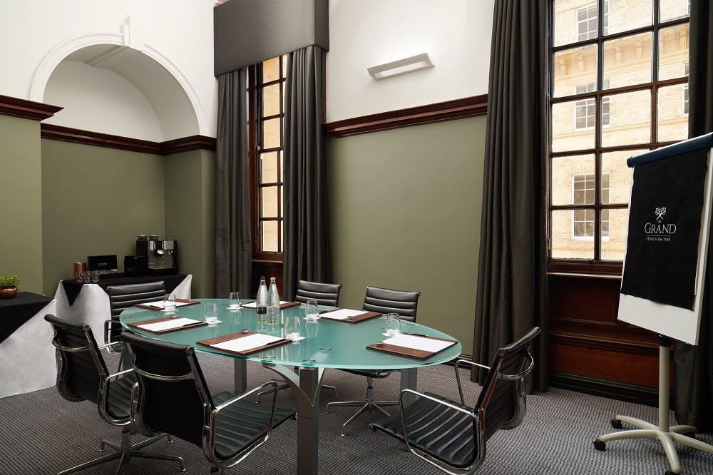 Modern meeting room in The Grand, York with glass table for corporate events.