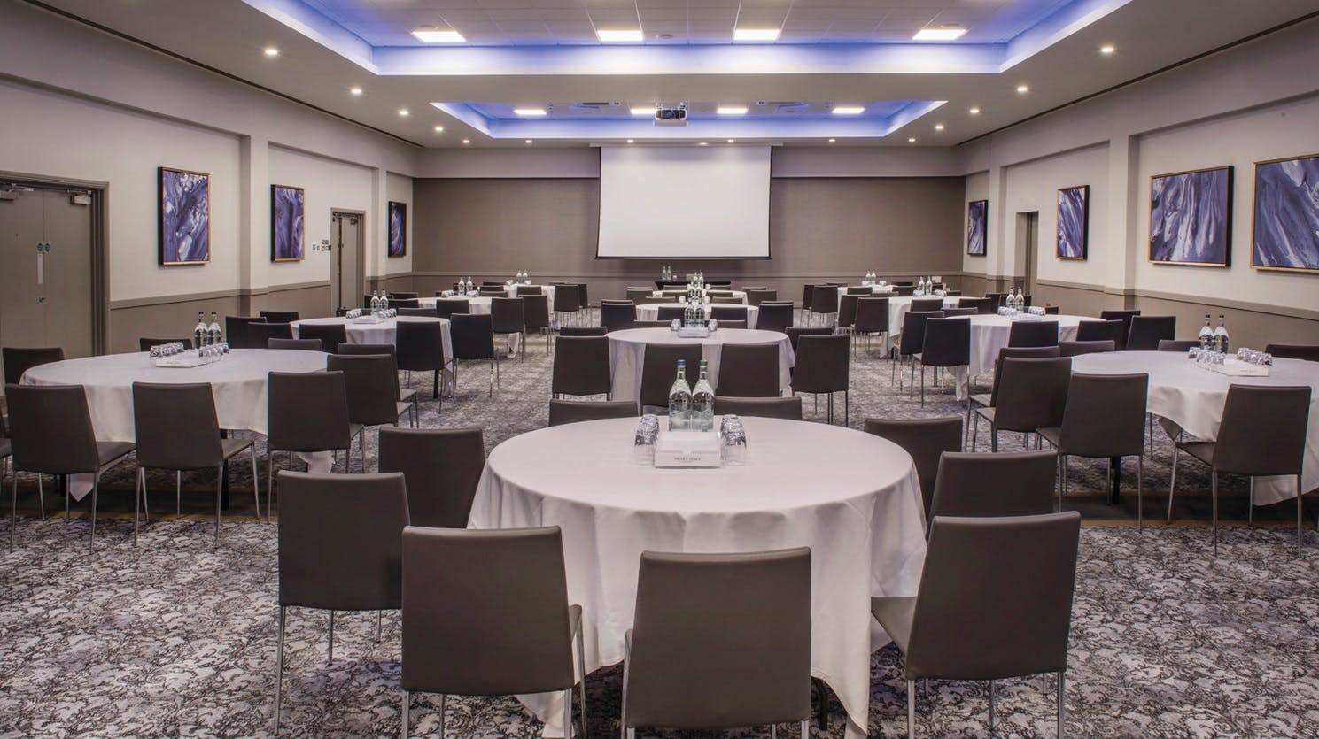 Wokefield Suite meeting space with round tables, ideal for conferences and workshops.