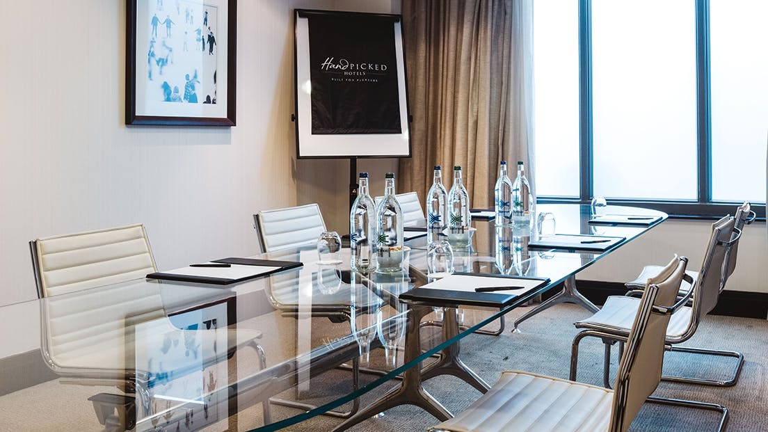 Modern meeting room in Alice Suite, Grand Jersey Hotel; ideal for professional events.