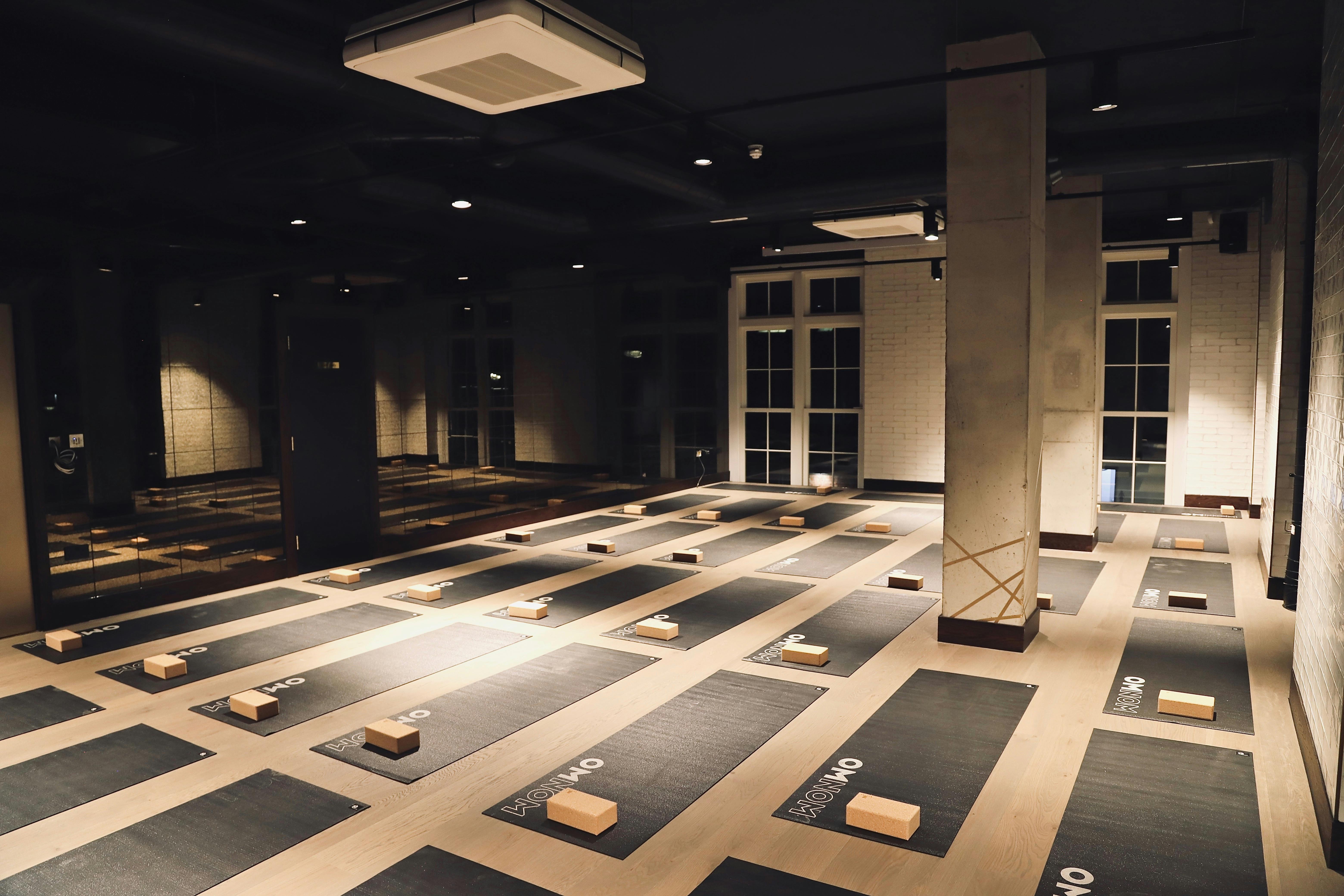Spacious yoga studio with mats, ideal for wellness events and corporate retreats.