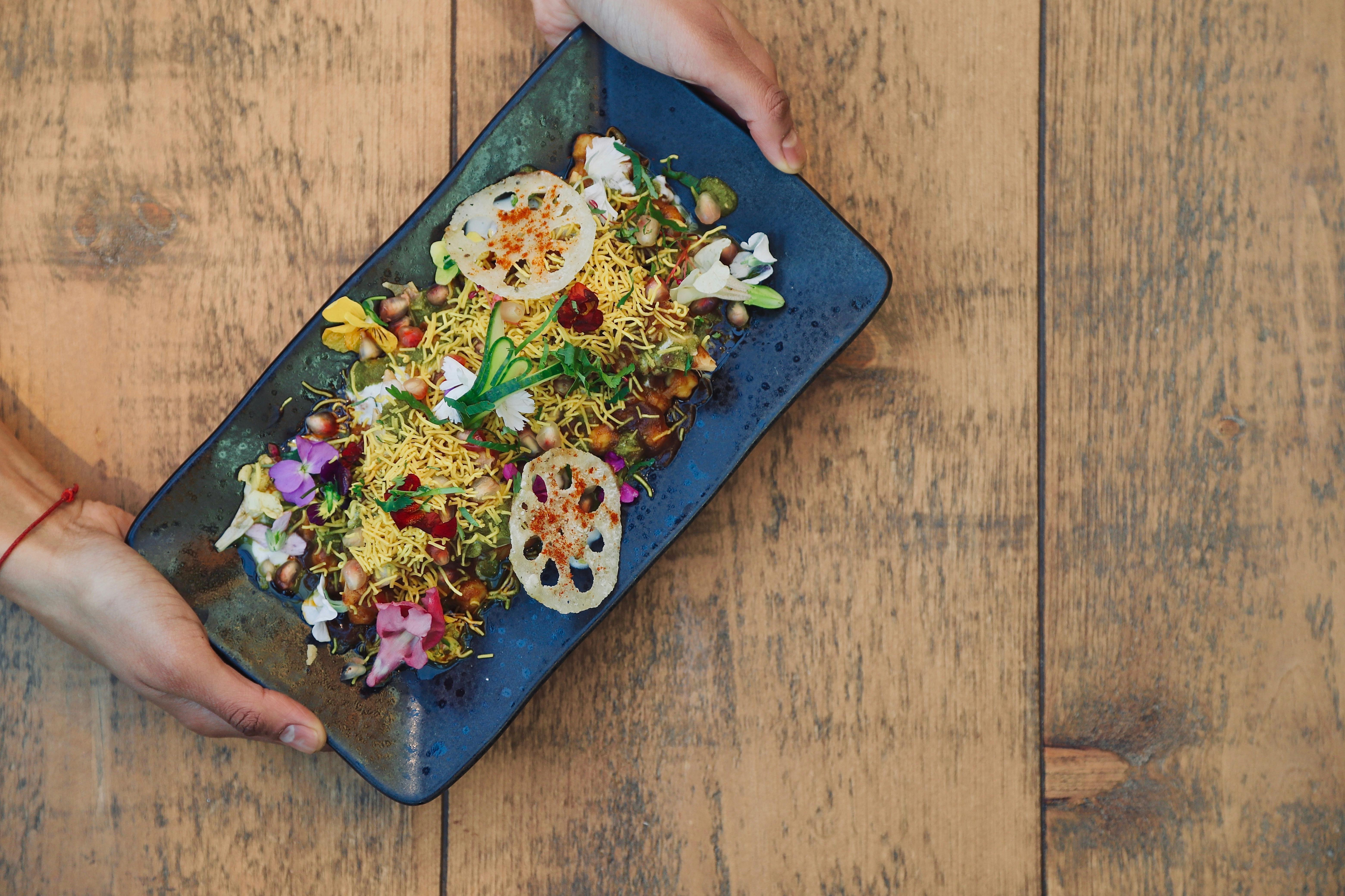 Gourmet dish at OmStudio, vibrant colors for upscale catering events.