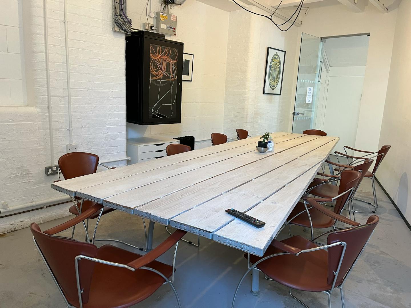 Modern meeting room with rustic table and leather chairs at Freedom Works, Hove.