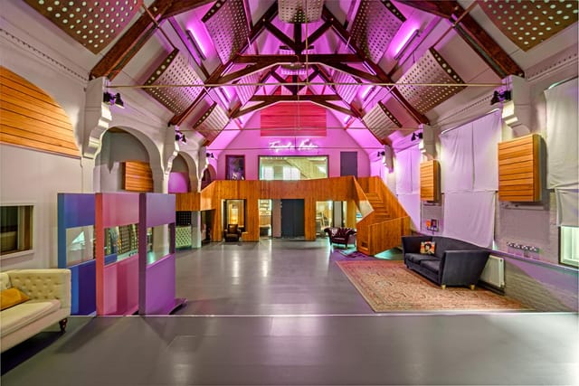 Modern event space with high ceilings, ideal for networking and celebrations.