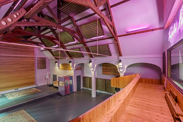 Versatile event space with high ceilings at The Empire Broadcasting Corporation for meetings and workshops.