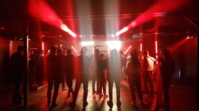 Dynamic event space at XOYO Birmingham with red lighting for vibrant gatherings.