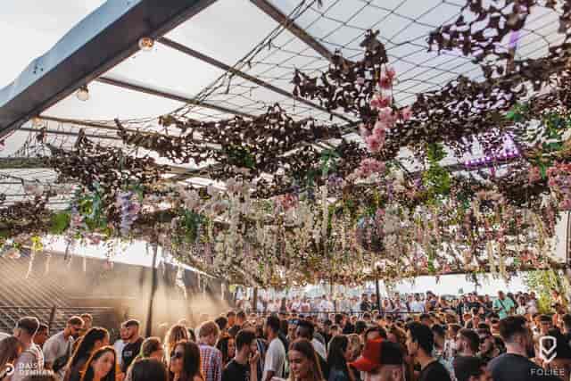 "Vibrant floral outdoor event space at XOYO Birmingham for networking and creativity."