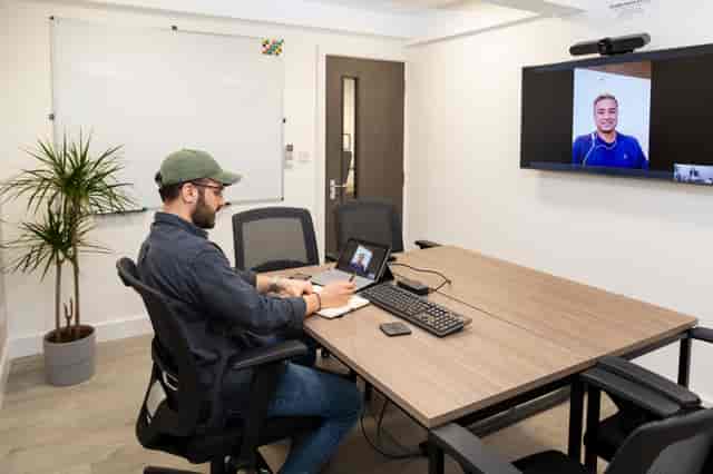 Modern meeting room with laptop, ideal for hybrid events and collaboration.