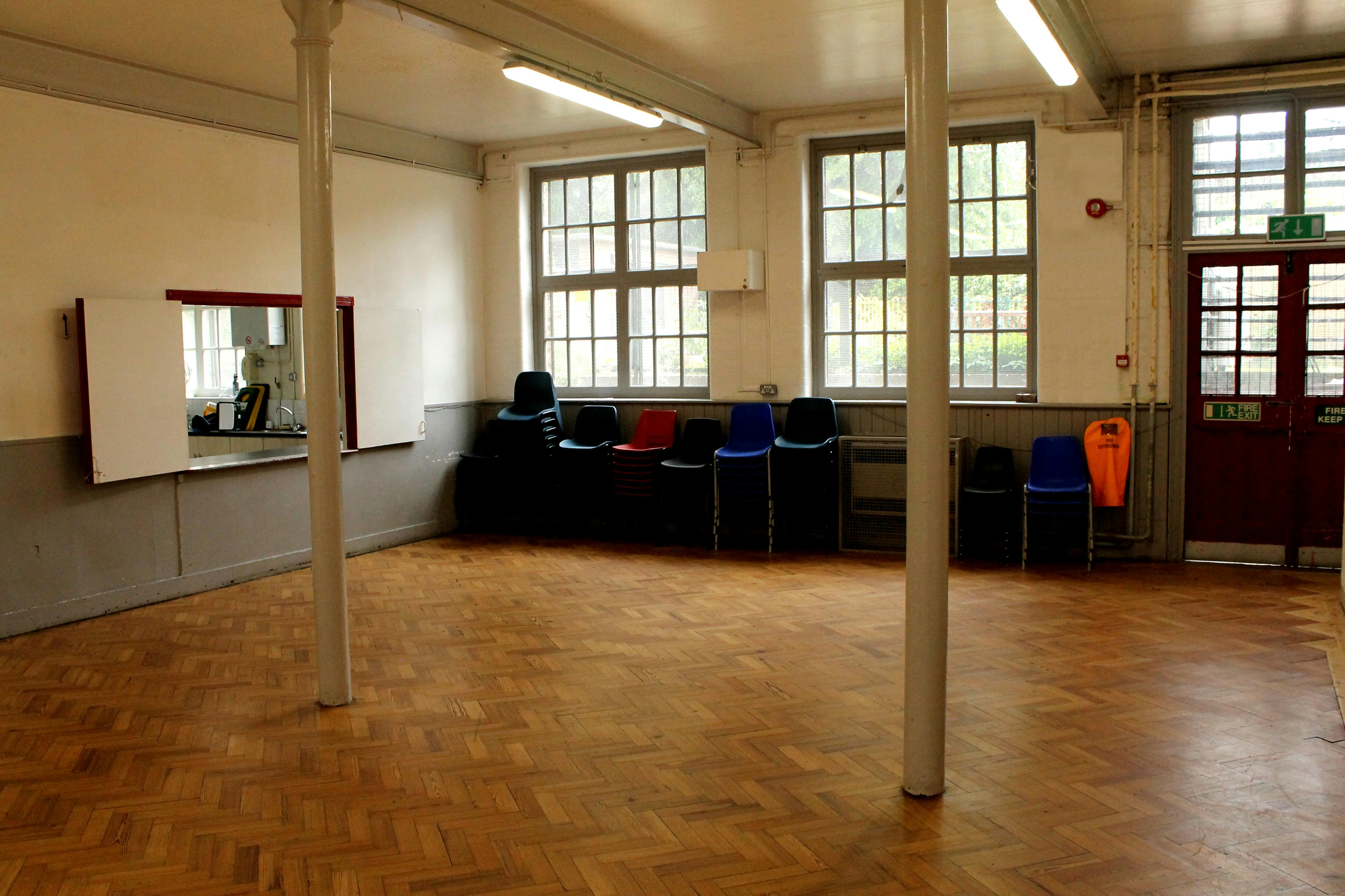 Versatile Lower Hall in Hargrave Hall with wooden flooring, ideal for workshops and gatherings.