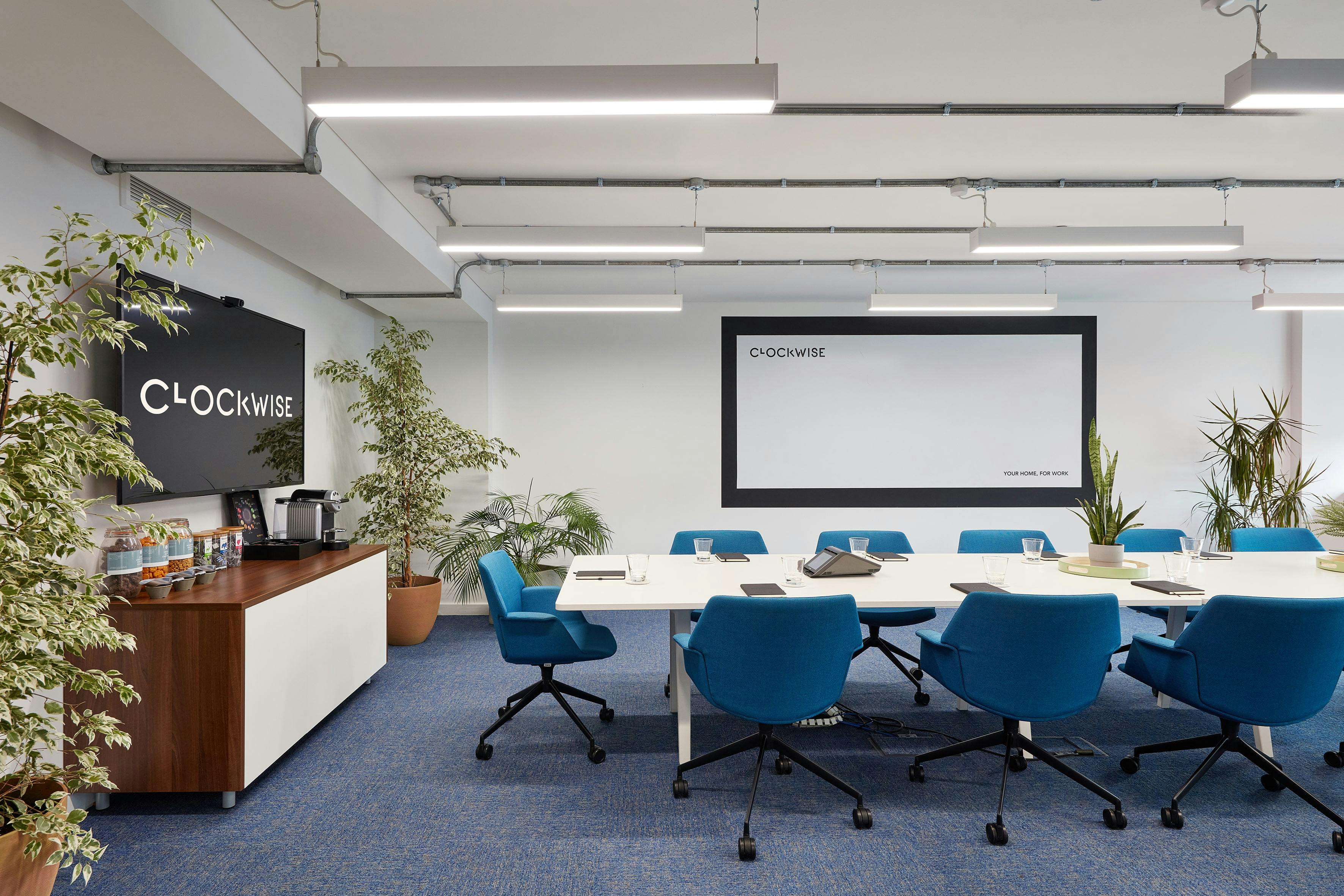 Modern meeting room in The Lagan Suite with blue chairs, ideal for collaboration and brainstorming.