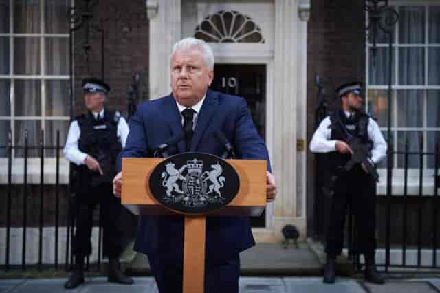 Press conference setup at RSA House with podium and security personnel.