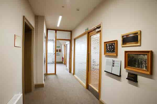 Well-lit corridor in Oxford House's Settlement Room, ideal for meetings and events.