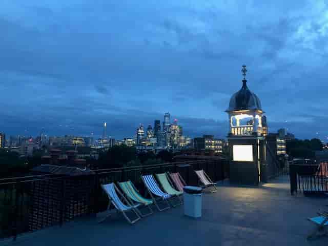 Rooftop terrace at Oxford House with city skyline, ideal for evening events and gatherings.