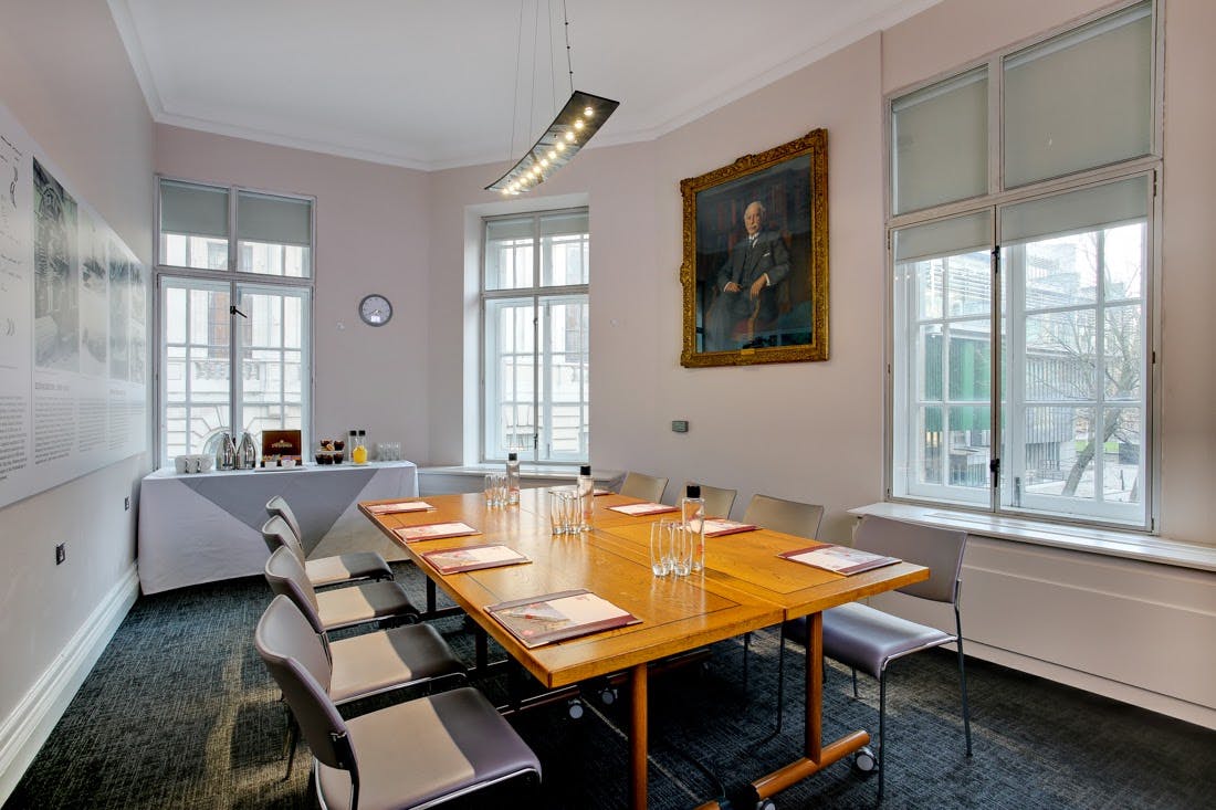 Charles Parsons in a modern meeting room with a large wooden table for professional gatherings.