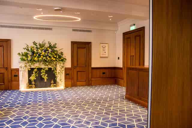 Elegant meeting space at Court Suites, featuring wood paneling and modern carpet.