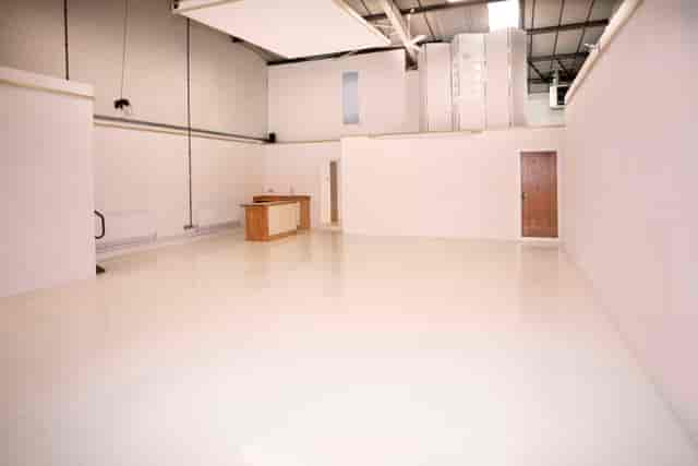 Versatile event space with clean white walls, ideal for meetings and workshops.