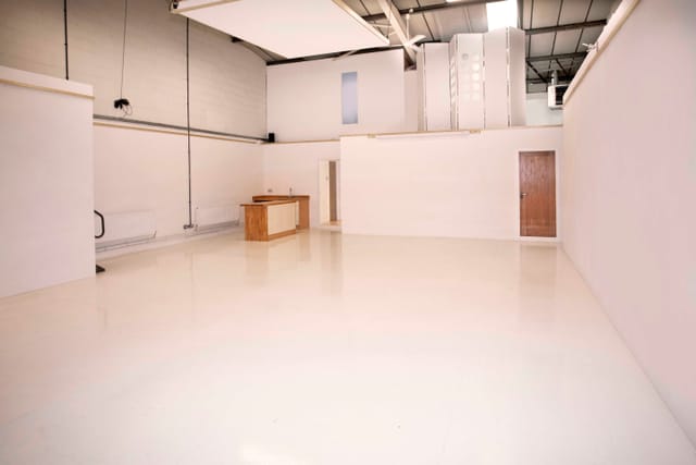 Versatile event space with clean white walls, ideal for meetings and workshops.