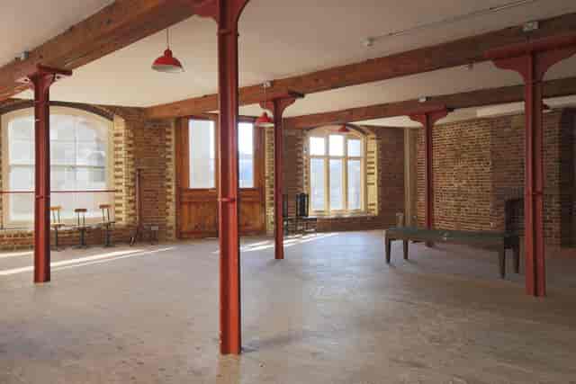 Industrial event space with exposed brick for creative workshops and product launches.