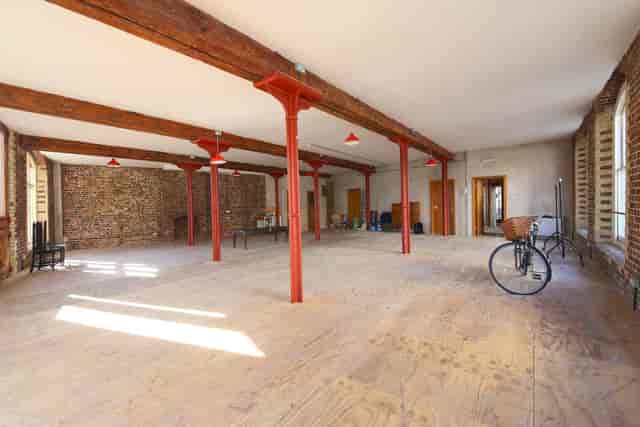 Industrial Menier Room venue with exposed brick, perfect for pop-up events and gallery exhibitions.