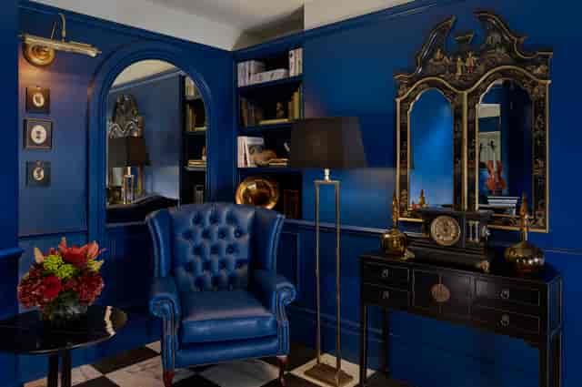 Sophisticated meeting space at Holmes Hotel London with rich blue walls, ideal for networking events.