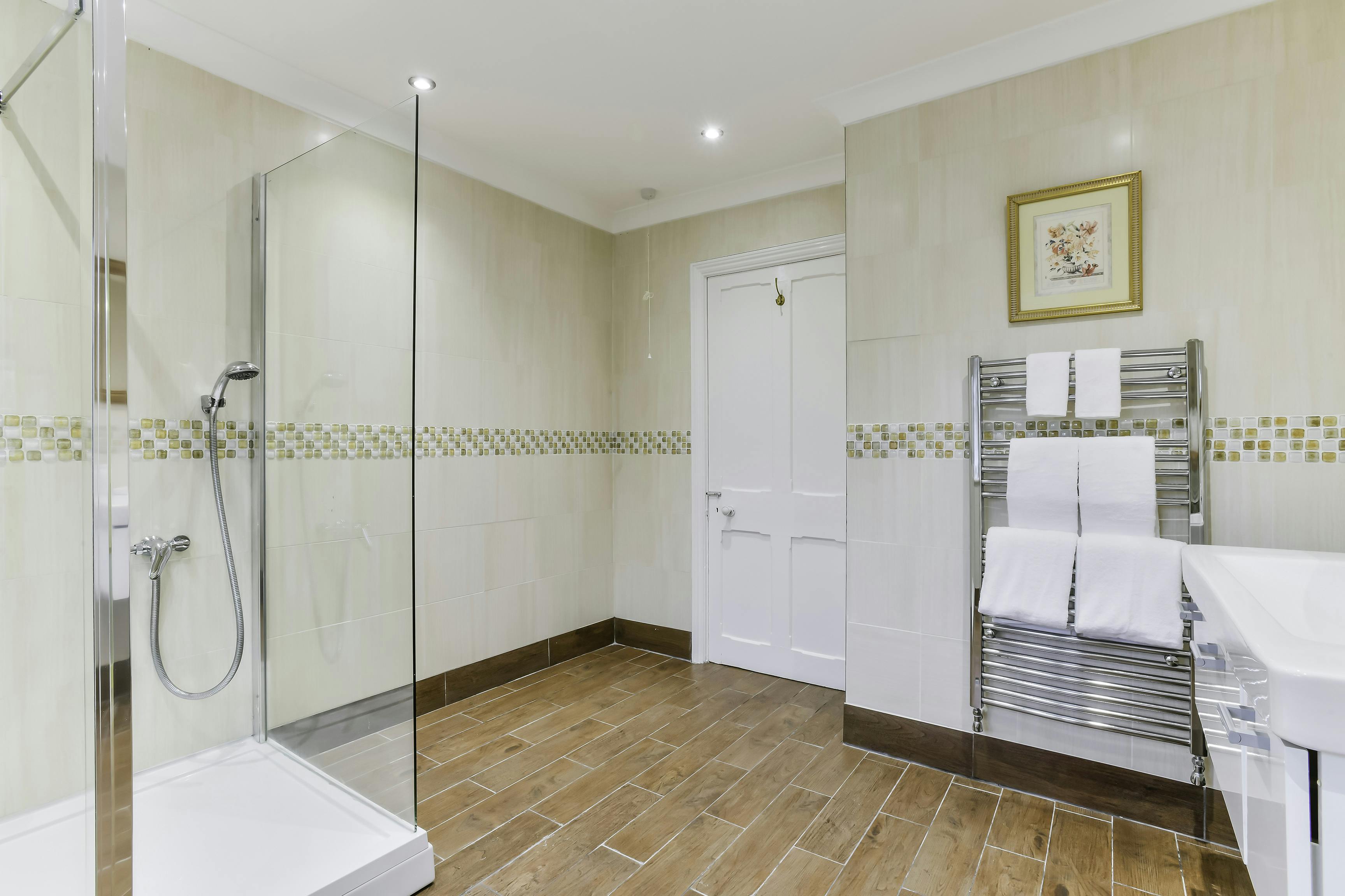 Modern bathroom at Kingswood Manor, featuring a glass shower for events and meetings.