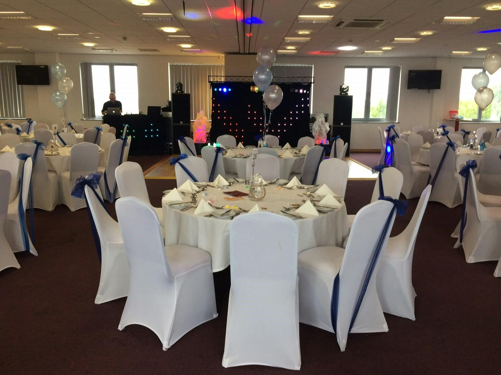 Elegant event space at Hull College Craven Park with blue accents and festive decor.