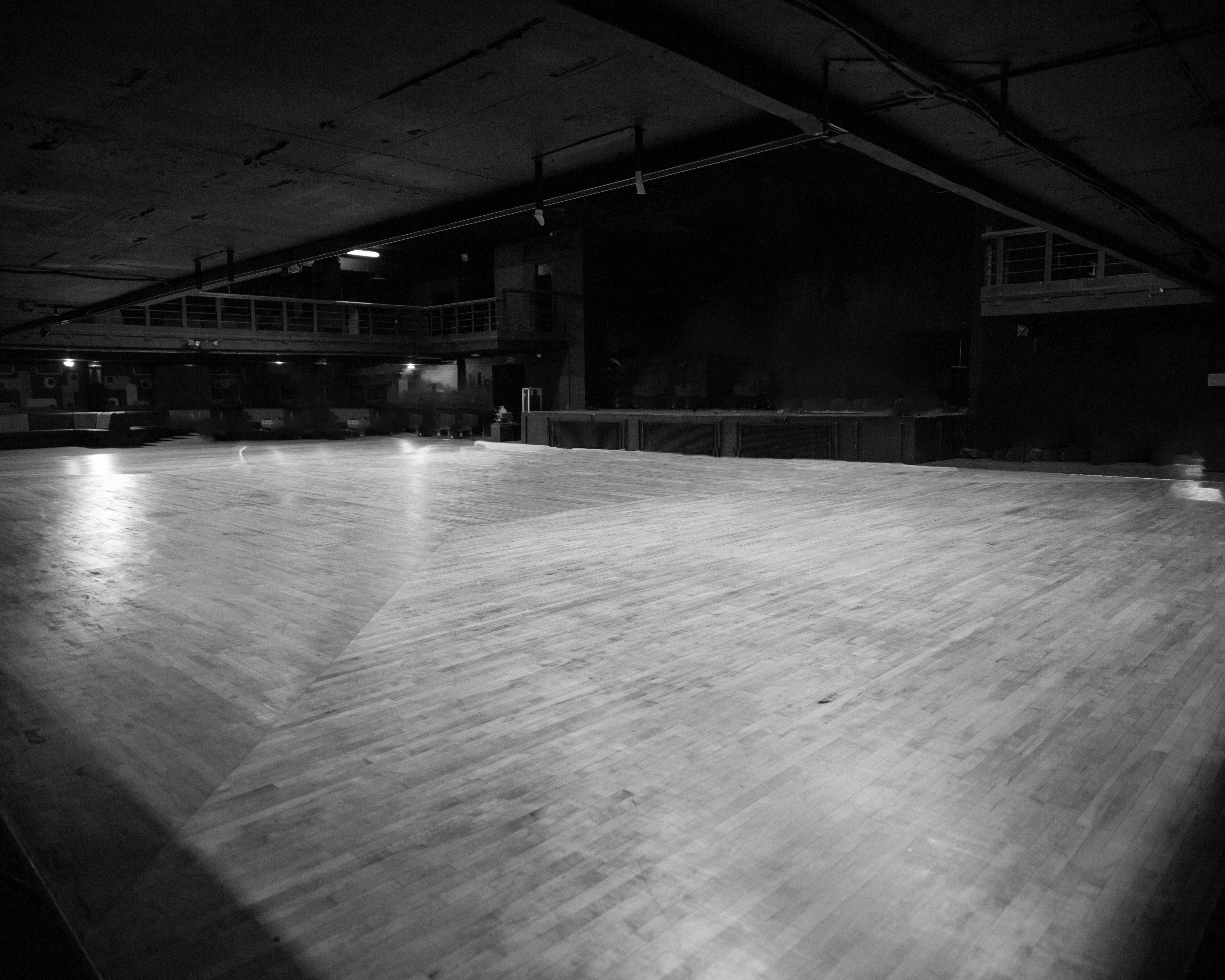 Spacious Forum HQ venue with polished wooden floor, ideal for events and conferences.