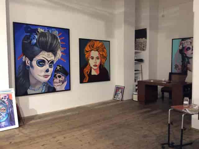 Vibrant art venue with striking portraits, perfect for exhibitions and themed parties.