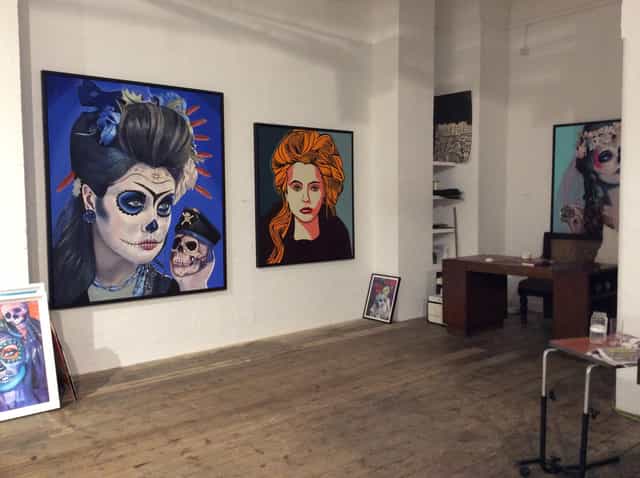 Vibrant art venue with striking portraits, perfect for exhibitions and themed parties.
