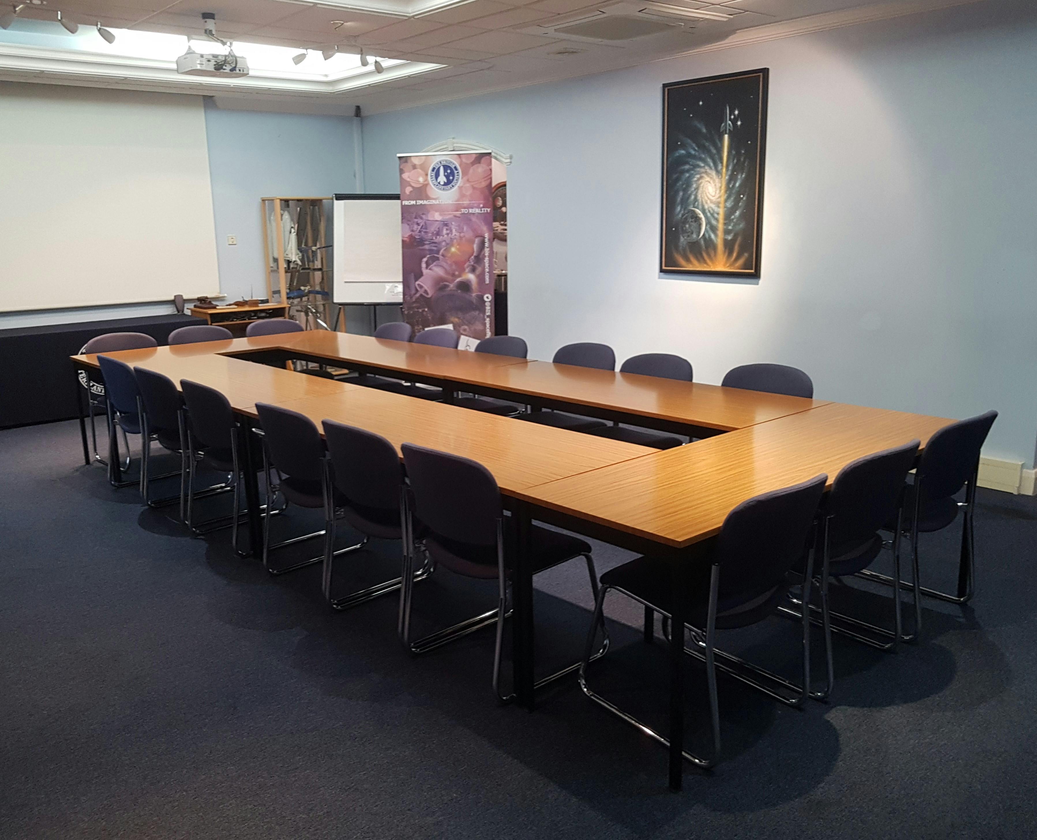 Golovine Lecture Hall with long table, ideal for meetings and presentations.