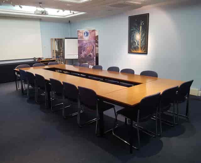 Golovine Lecture Hall with long table, ideal for meetings and presentations.