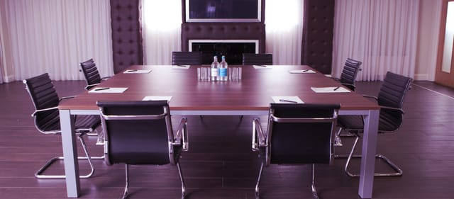 Vice President's Lounge at Selhurst Park, modern meeting room with large table and chairs.