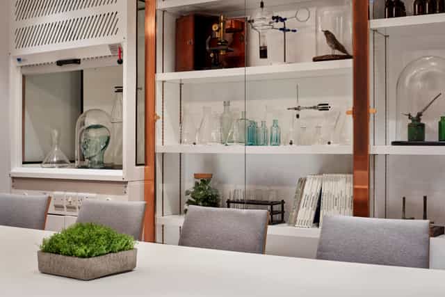 Modern meeting space at Holmes Hotel London with sleek table and scientific decor.