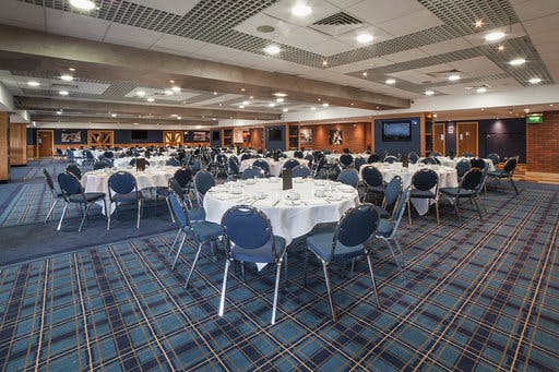 Jacks Lounge at Ewood Experience, elegant venue for corporate events with round tables.