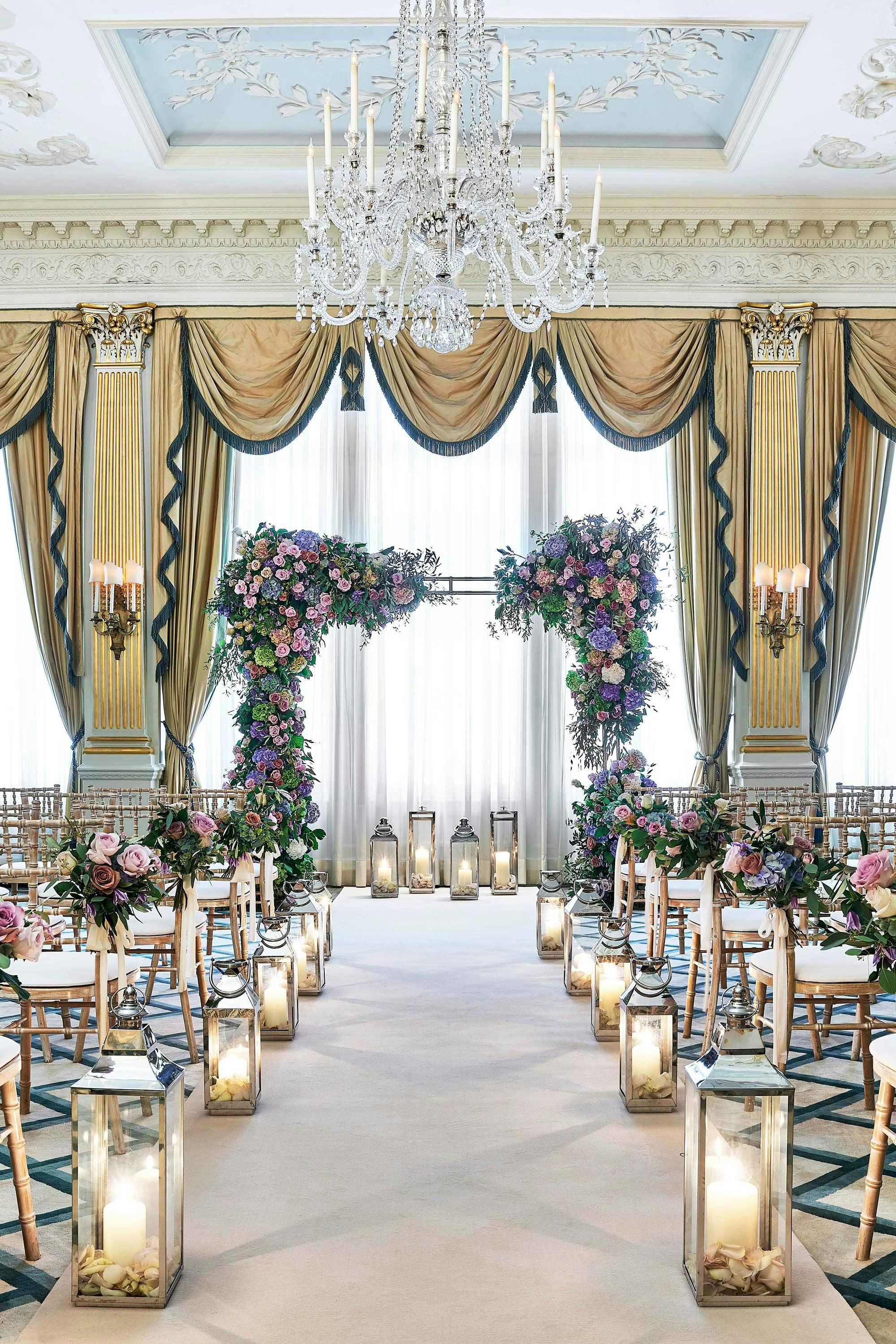 Elegant wedding ceremony setup with floral arch at Claridge's Drawing Room.