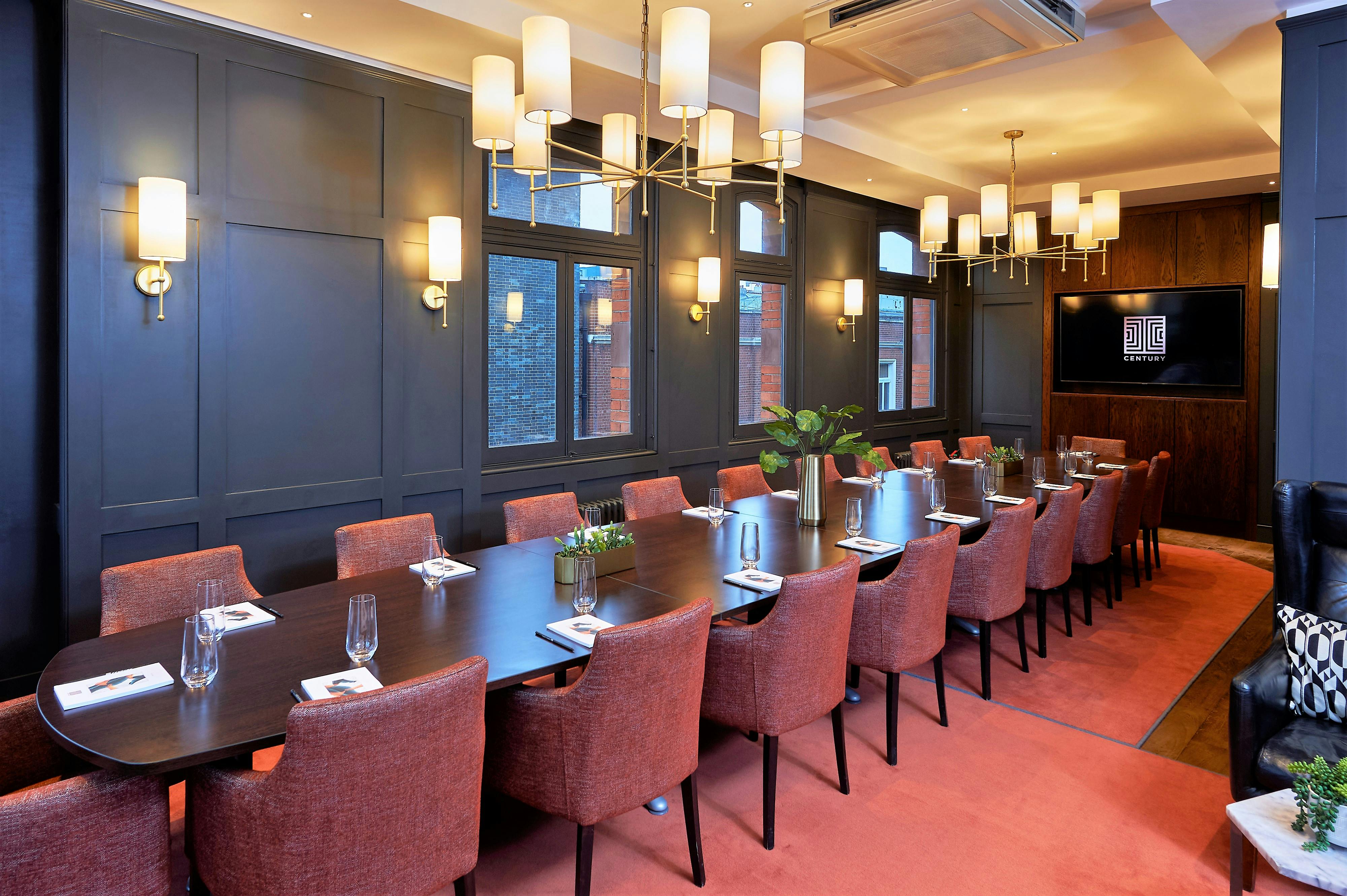 Sophisticated meeting room at Century Club with elegant table and plush chairs.