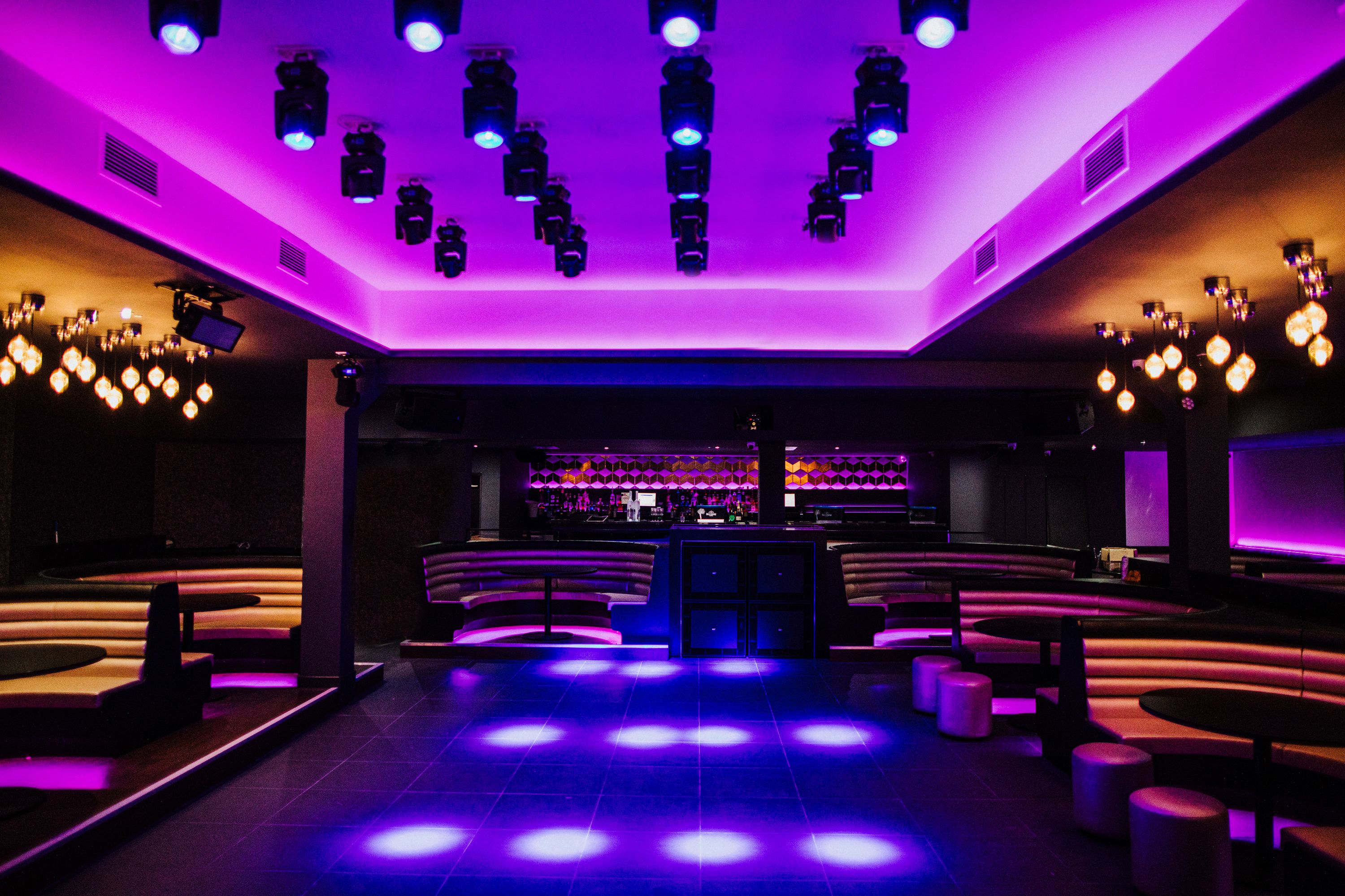 Modern event space with purple lighting, perfect for social and corporate gatherings. - Banner