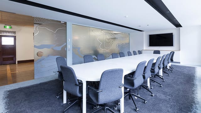 Modern conference room at L8 Cafe, featuring a sleek table and ergonomic chairs for collaboration.