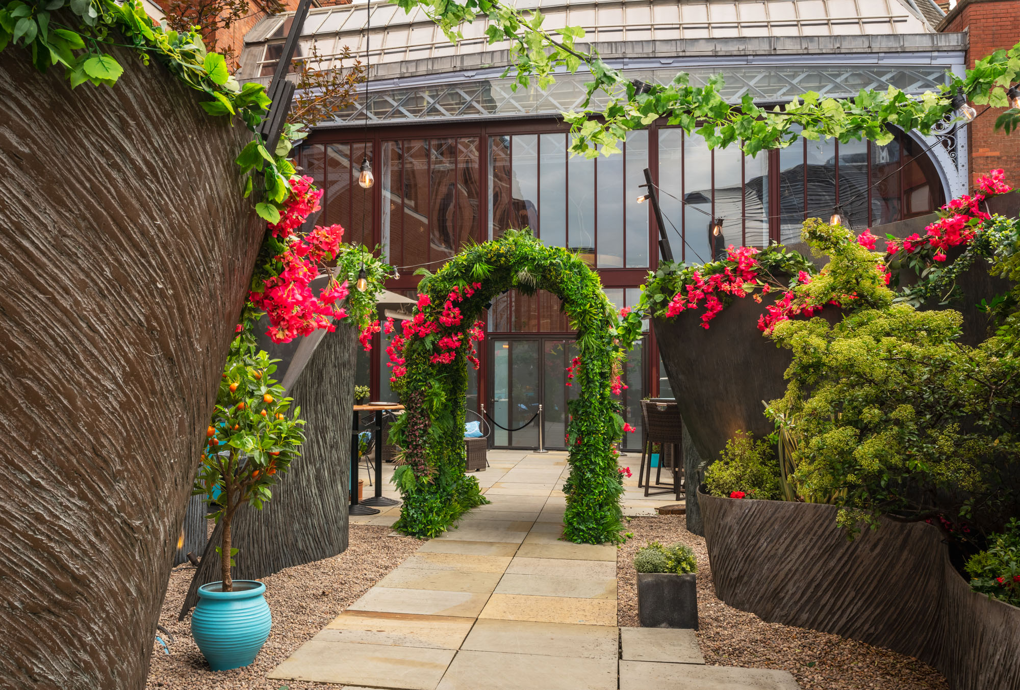 Lush floral archway at RoofGarden St. Pancras, perfect for weddings and garden parties. - Banner