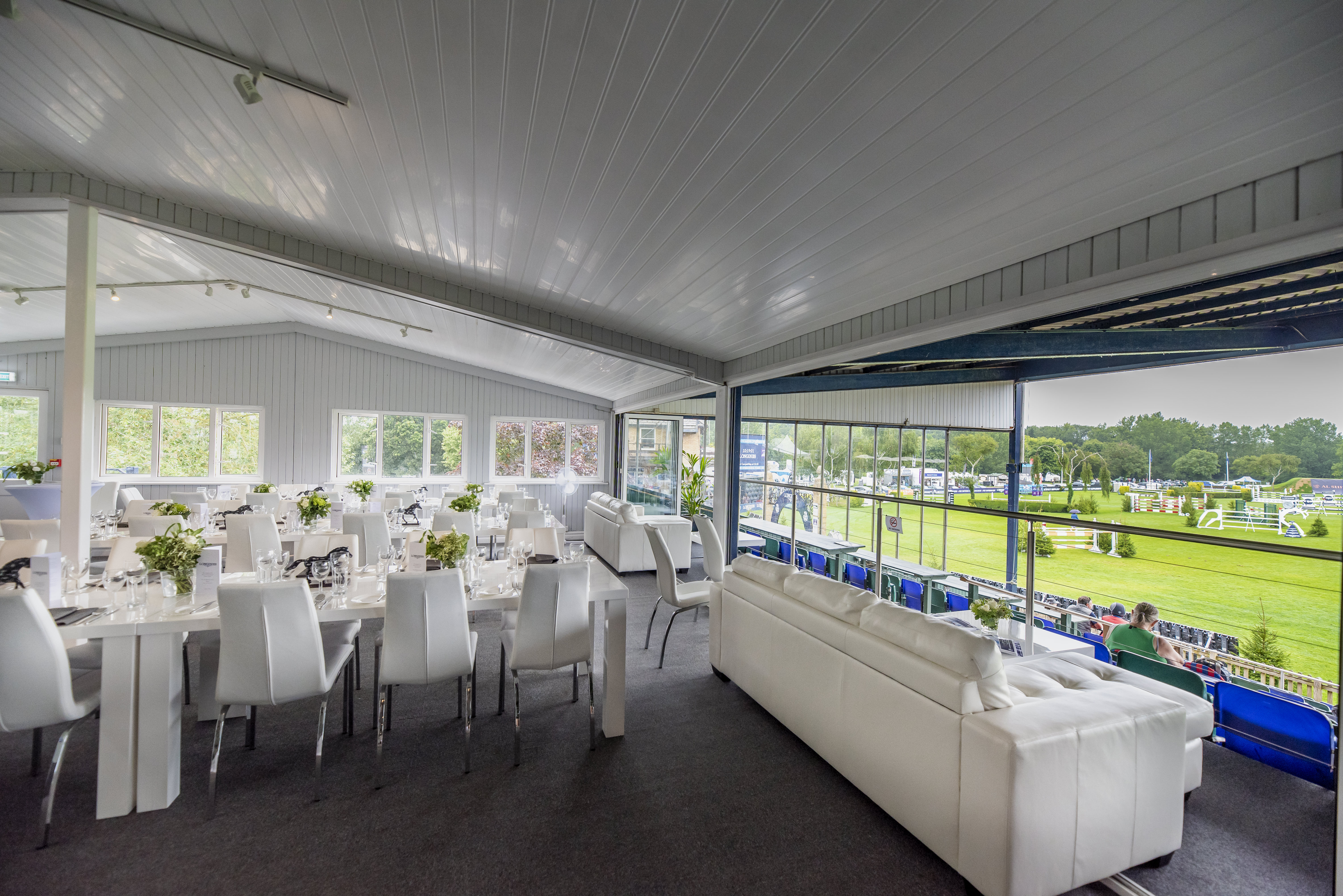 Al Shira'aa Suite at Hickstead: elegant event space with modern decor for upscale gatherings. - Banner