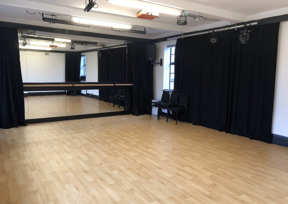 Versatile event space with polished wooden floor for workshops and dance classes.