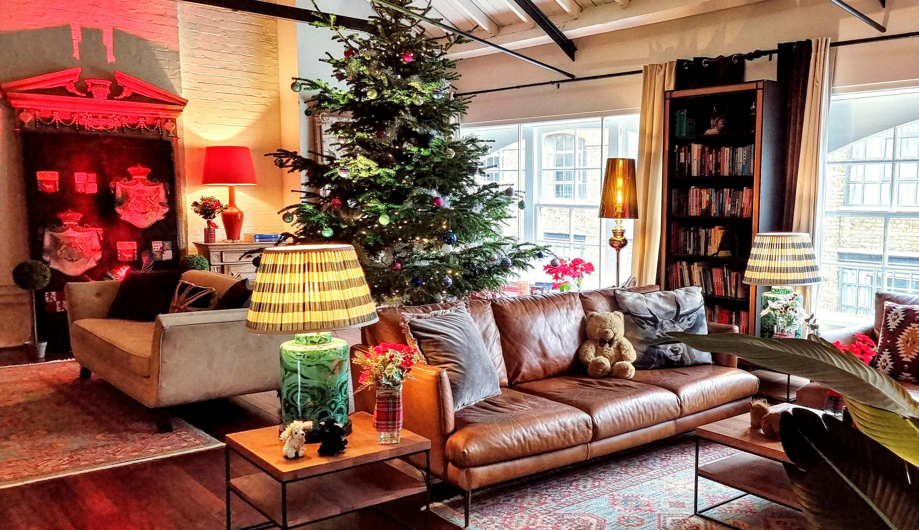 Cozy living space with Christmas tree for intimate holiday gatherings and events.