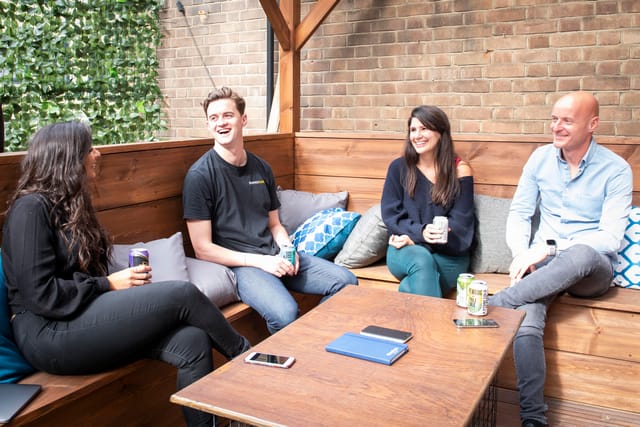 Casual meeting space at Runway East Soho with greenery, ideal for team-building activities.