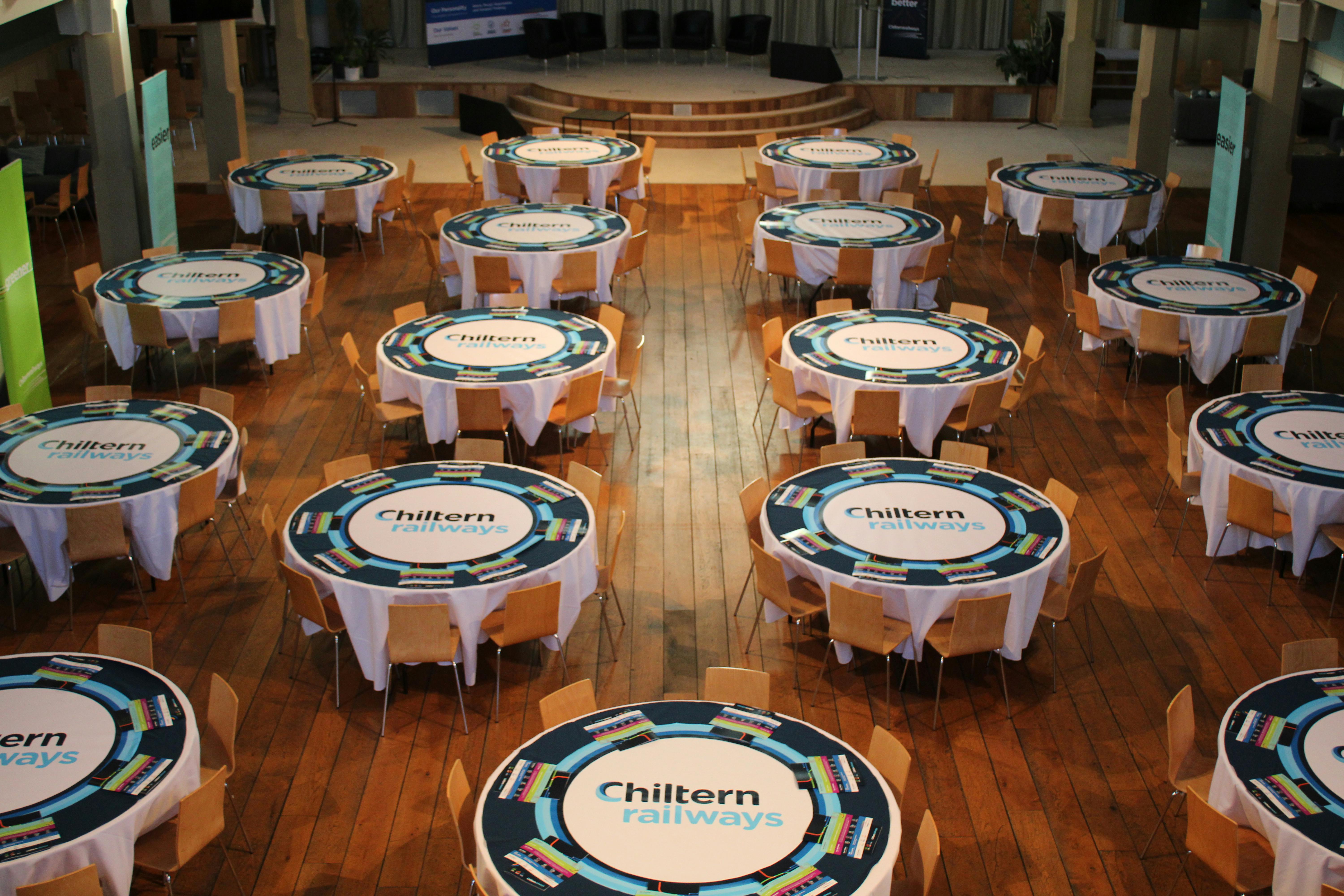 Corporate event space in St Mary's Marylebone with branded tables for networking.
