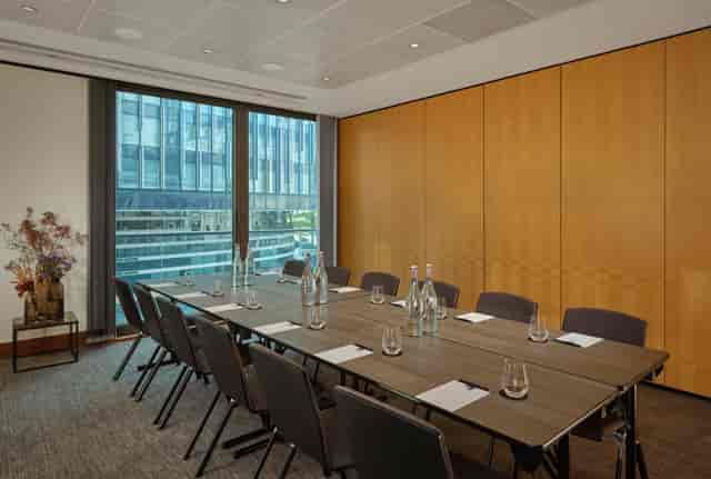 Modern Putney Suite meeting room with wooden paneling, ideal for professional events.