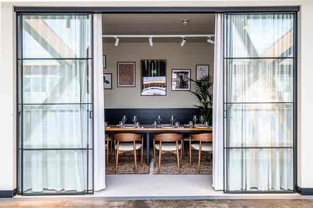 Stylish meeting space with long table, ideal for intimate gatherings and networking events.