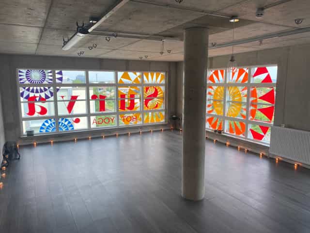 Spacious Surya Studio 2 with stained glass, perfect for yoga classes and workshops.
