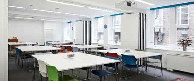 Versatile meeting space with modular tables and colorful chairs for workshops in Covent Garden.
