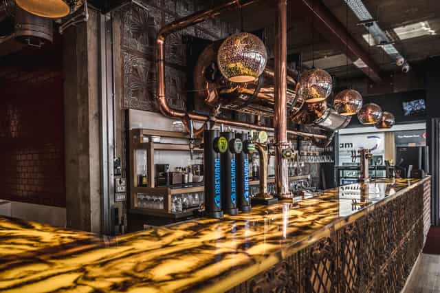 Stylish bar with illuminated countertop in Dough Dough Liverpool, perfect for events.